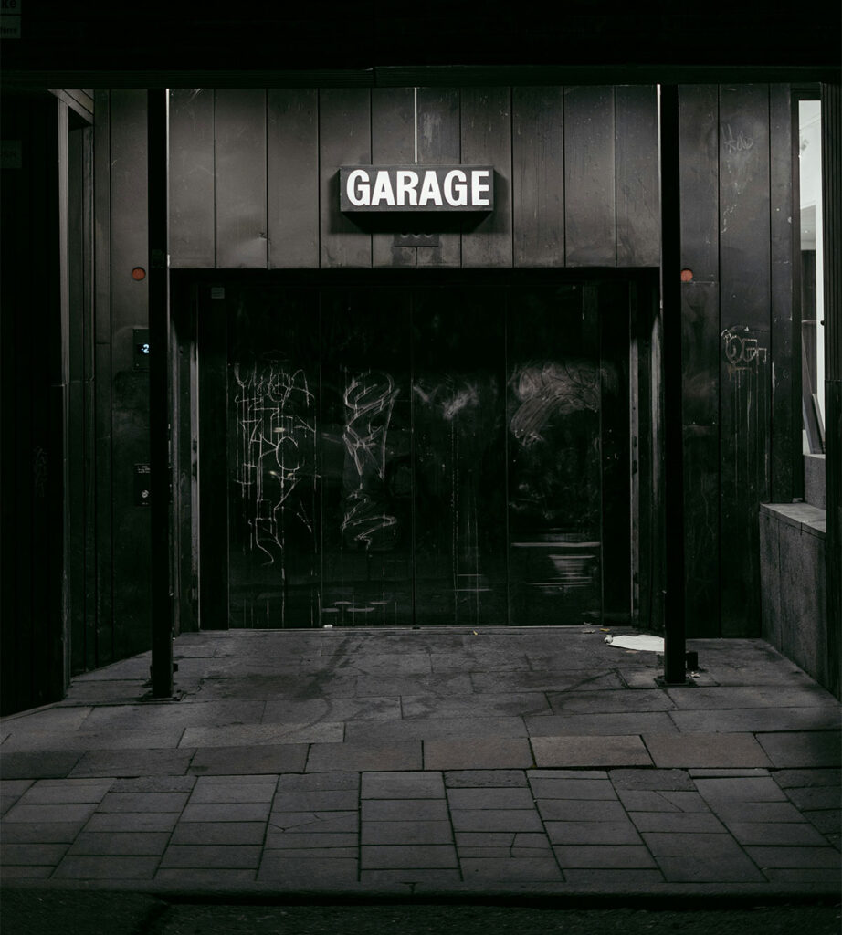 Dark-garage-entrance-with-illuminated-sign