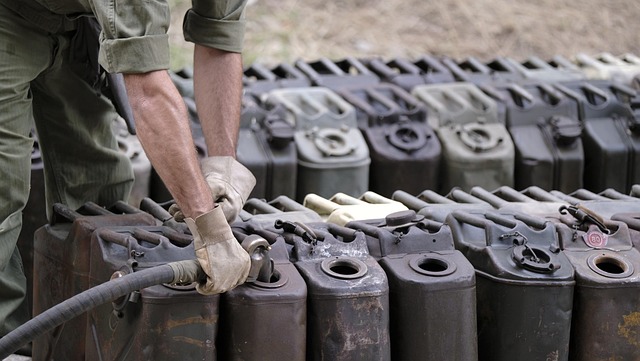 photo of person filling fuel in gallons
