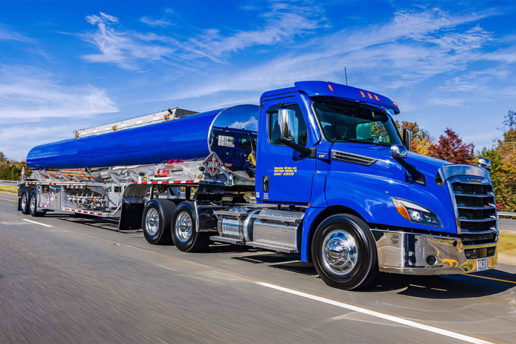Blue fuel tanker truck driving on highway