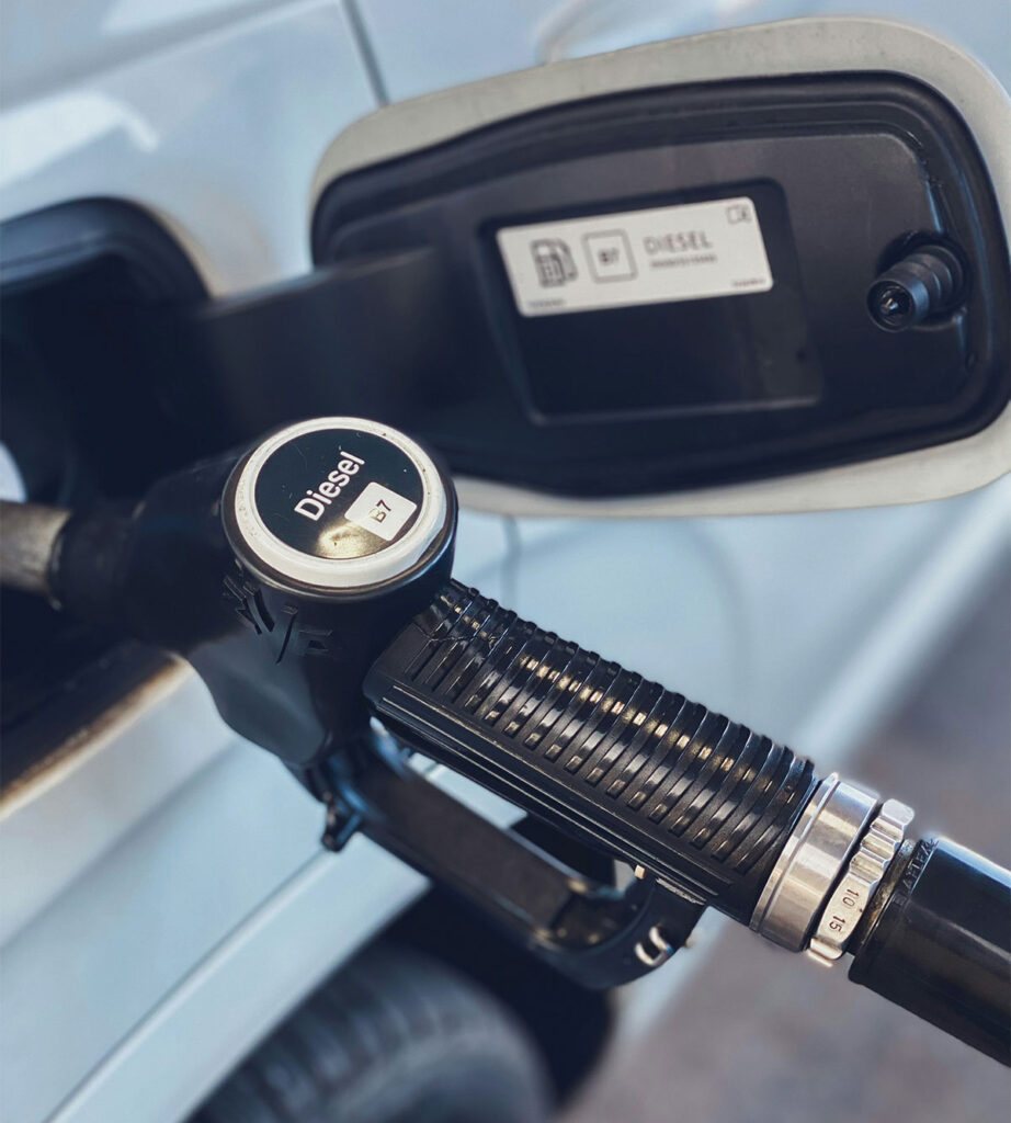 Diesel fuel nozzle inserted into vehicle tank