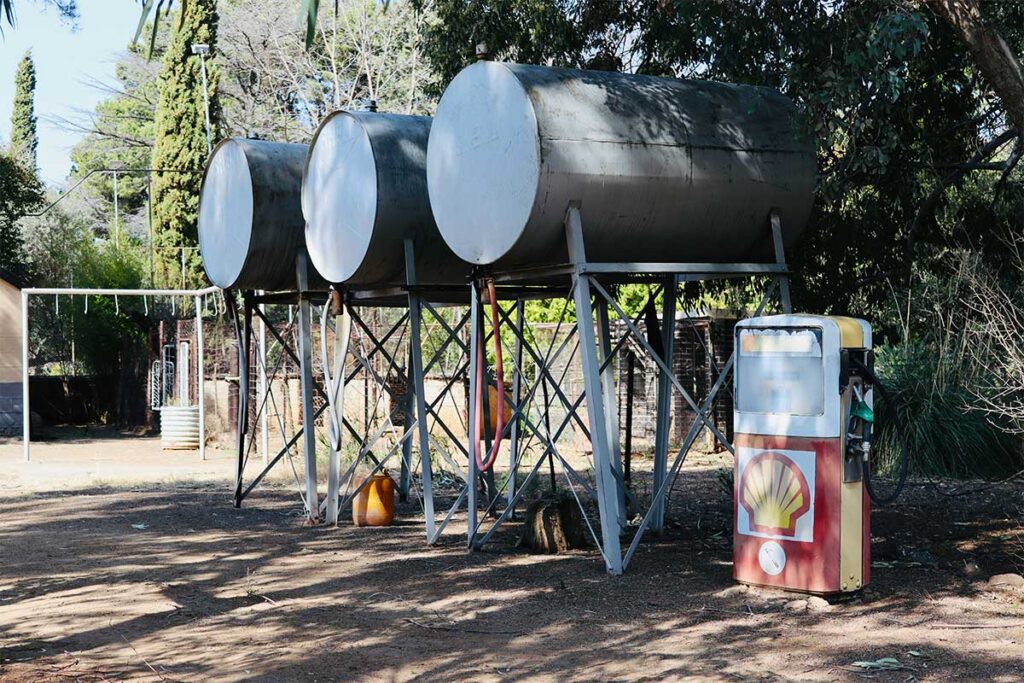 Elevated fuel tanks beside vintage gasoline pump
