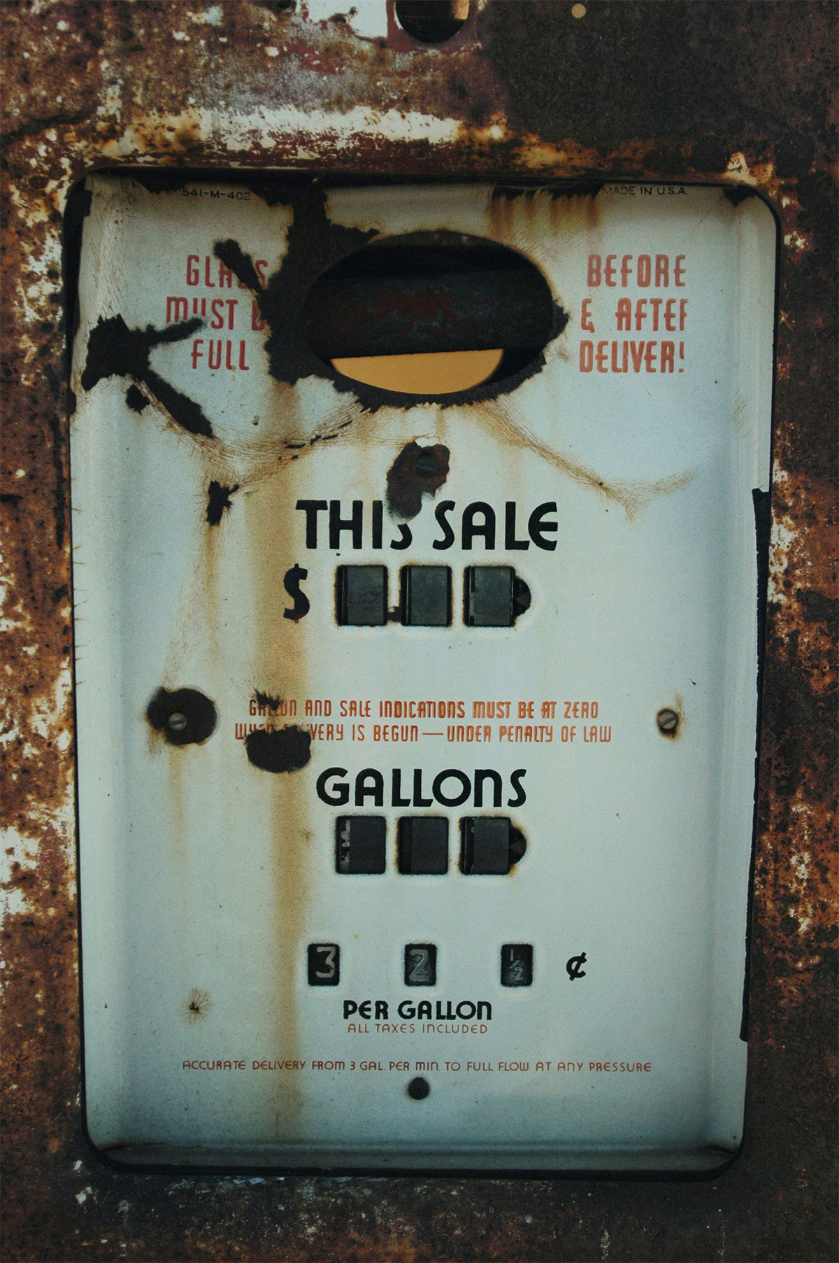 Rusty vintage gas pump showing sale display