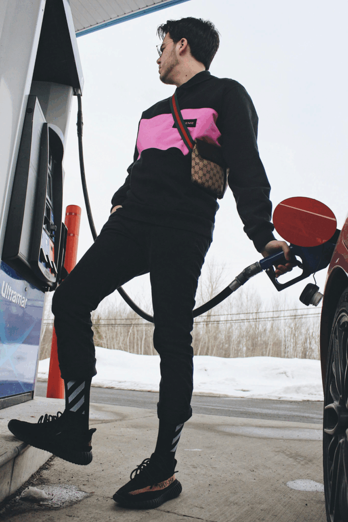 Stylish man pumping fuel into a car