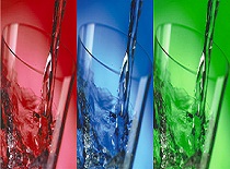 Three glasses with dyed red, blue, green liquid