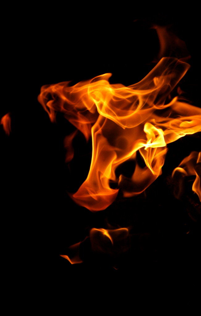 bright flame against black background