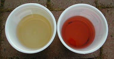 two cups, one with good gasoline, the other with bad gasoline