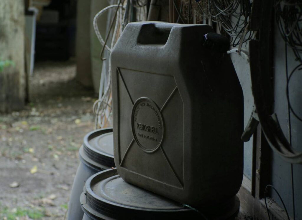 Black jerry can standing on black drum (1)