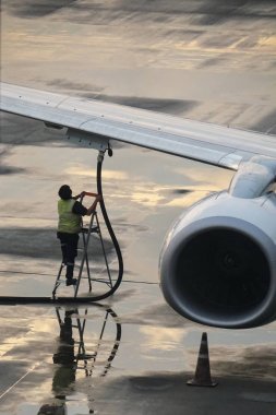 Man filling aircraft on tarmac
