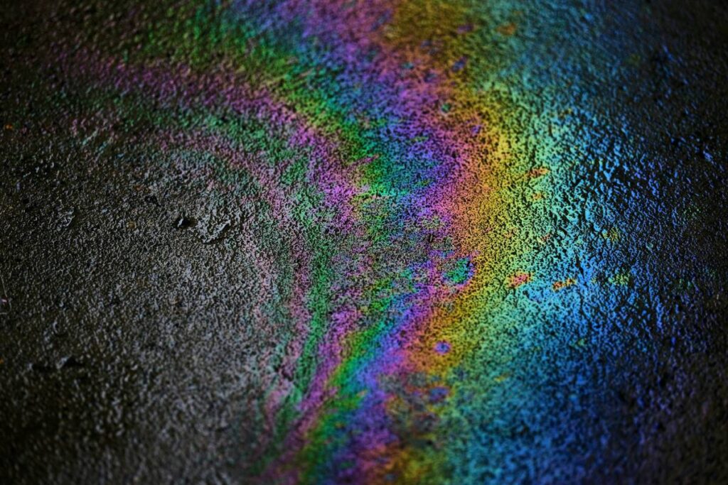Oil spill forming pattern on tar