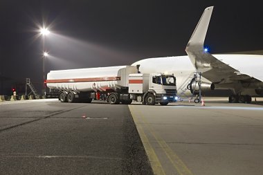 Airplane being fueled at night