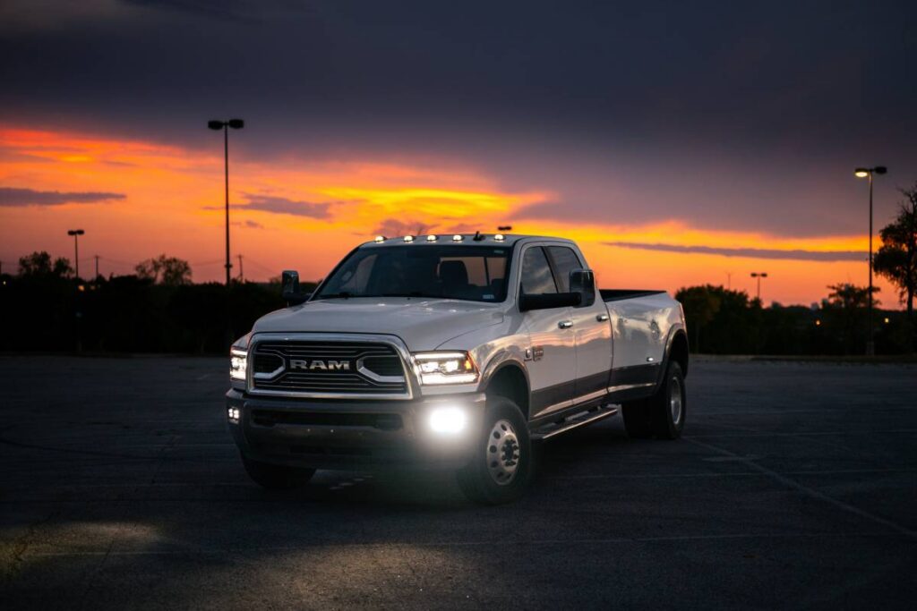 Parked white truck with headlights beaming