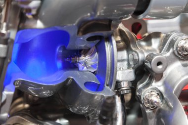 Turbocharger attached to diesel engine in factory