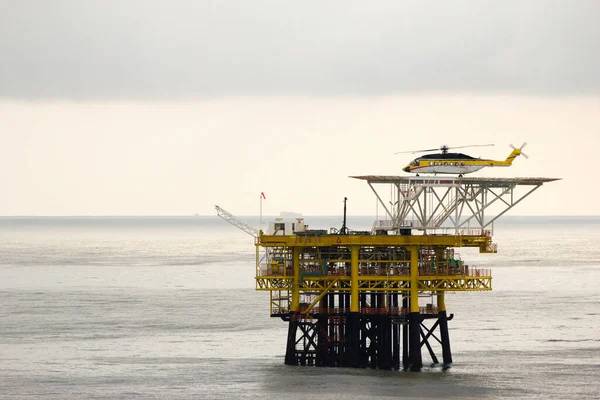 Helicopter landing on oil rig