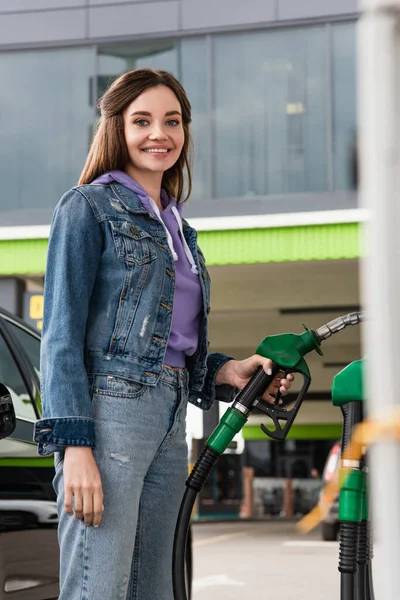 Woman pumping gasoline